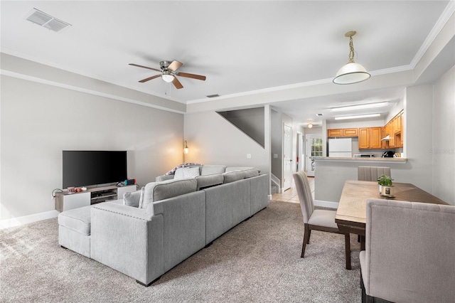 living area featuring light carpet, ceiling fan, visible vents, and baseboards