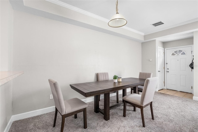 dining room with light tile patterned flooring, light colored carpet, visible vents, baseboards, and crown molding