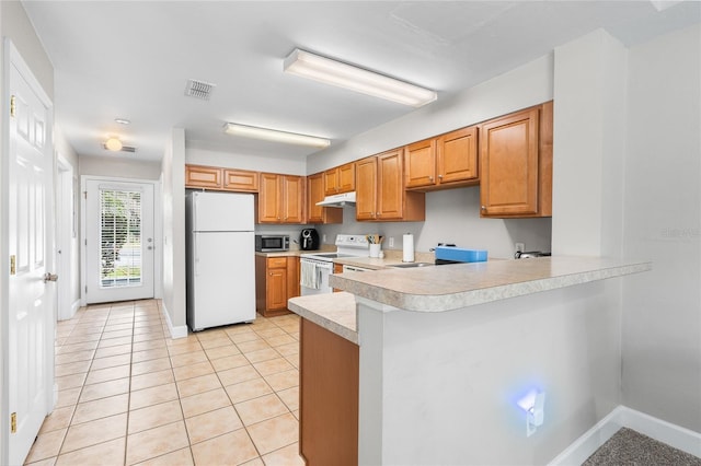 kitchen with white appliances, visible vents, a peninsula, light countertops, and under cabinet range hood