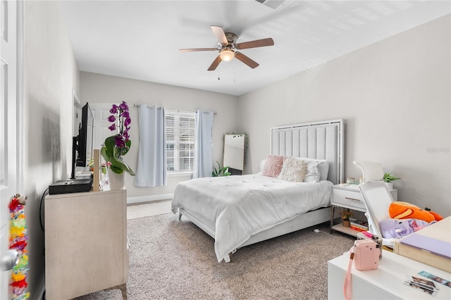 bedroom featuring ceiling fan, carpet flooring, and baseboards