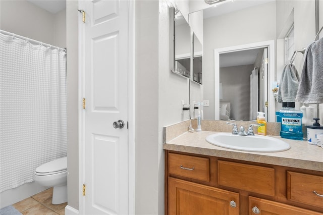 bathroom with connected bathroom, toilet, tile patterned flooring, vanity, and a closet