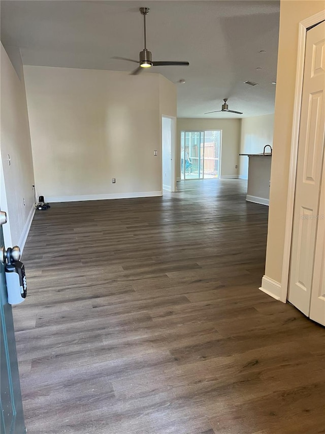 empty room with visible vents, baseboards, ceiling fan, and wood finished floors