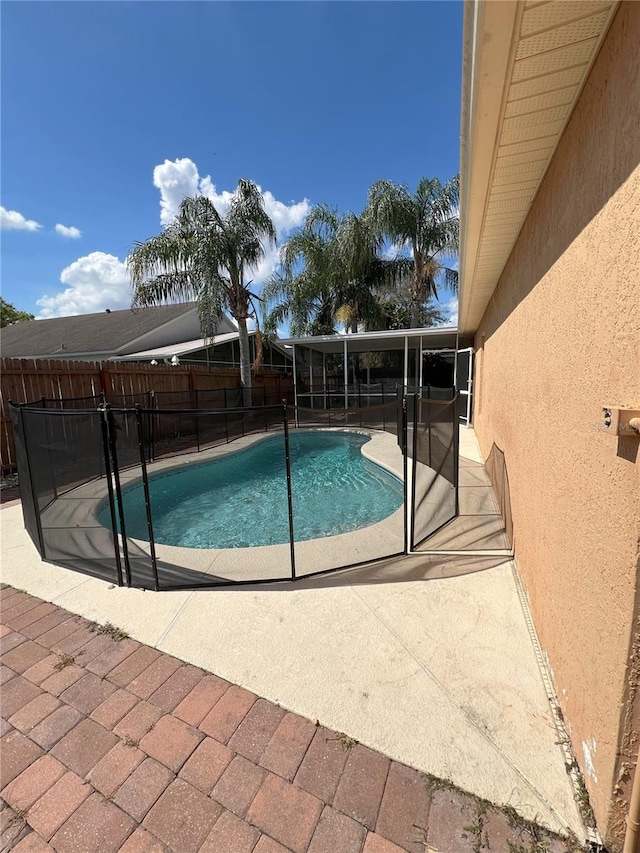 view of swimming pool with a fenced in pool, a patio, and fence