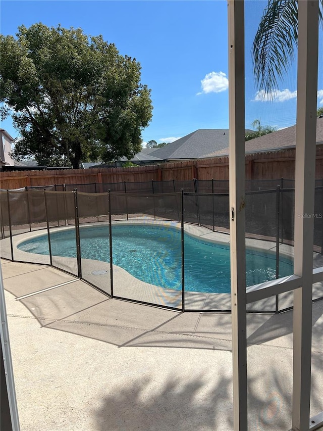 view of swimming pool featuring a fenced in pool, a patio, and a fenced backyard