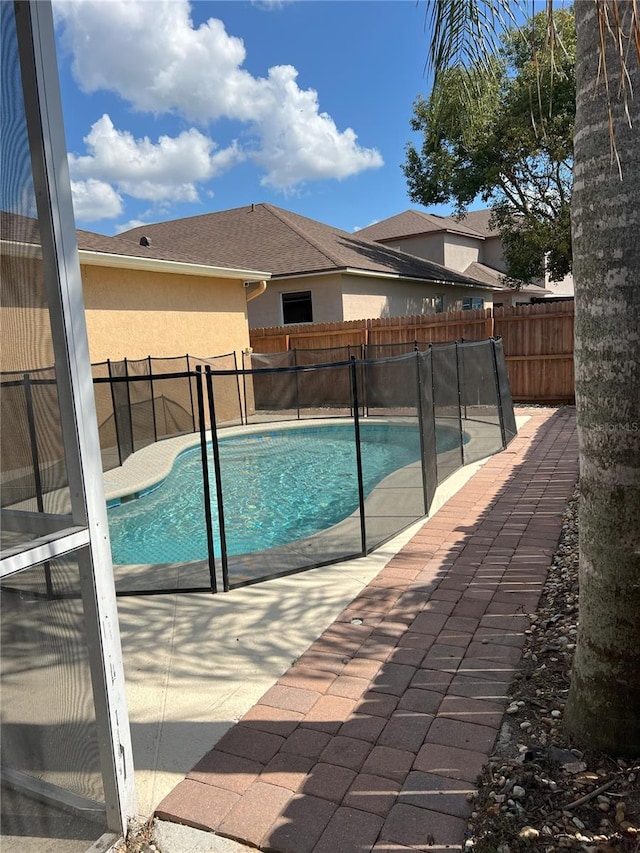 view of swimming pool featuring a fenced in pool, a patio, and a fenced backyard