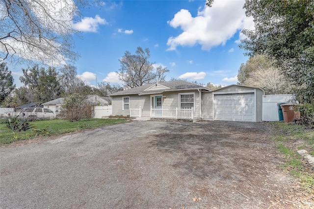 single story home with driveway and fence