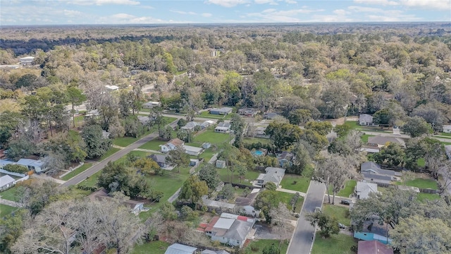 drone / aerial view featuring a residential view and a wooded view