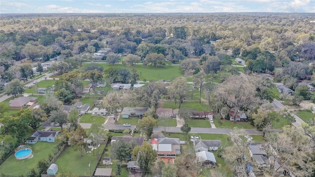 drone / aerial view with a forest view and a residential view