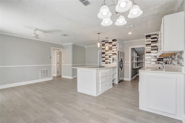 kitchen with stainless steel fridge with ice dispenser, visible vents, open floor plan, and light countertops