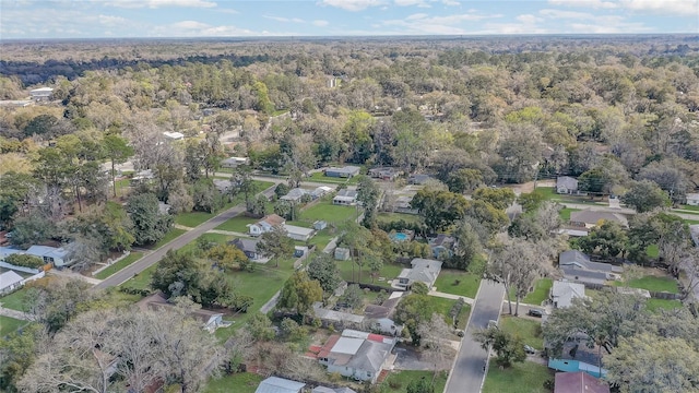 aerial view featuring a wooded view and a residential view