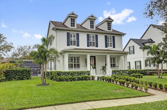 view of front of property featuring a porch, a front yard, fence, and stucco siding