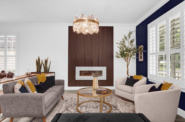 living area featuring a fireplace, an inviting chandelier, ornamental molding, wood finished floors, and baseboards