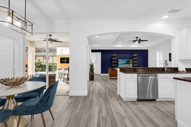 kitchen featuring visible vents, dark countertops, open floor plan, pendant lighting, and stainless steel dishwasher