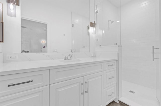 bathroom featuring a shower stall and vanity