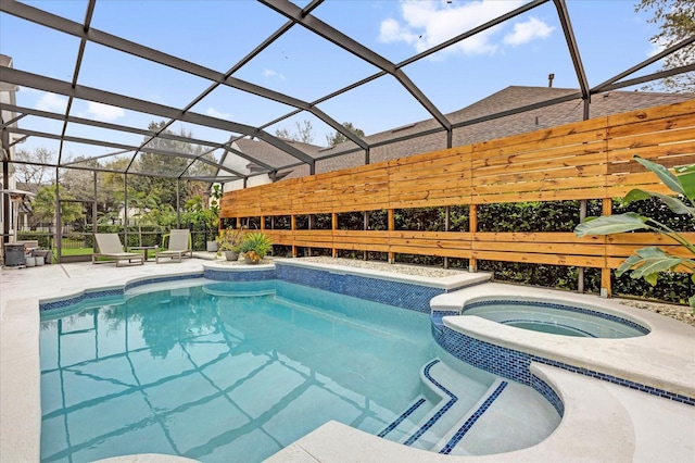 view of pool with glass enclosure, a patio, and a pool with connected hot tub