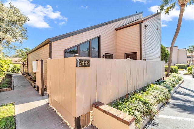 view of home's exterior with fence