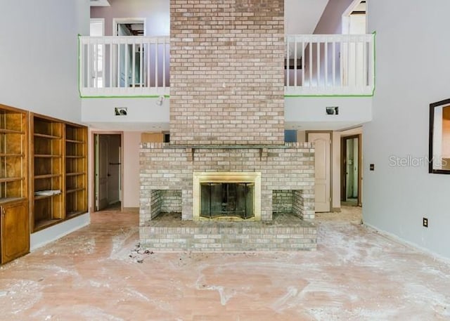 106 Thurston Pl, Crestview, FL 32536 - unfurnished living room featuring a towering ceiling and a brick fireplace