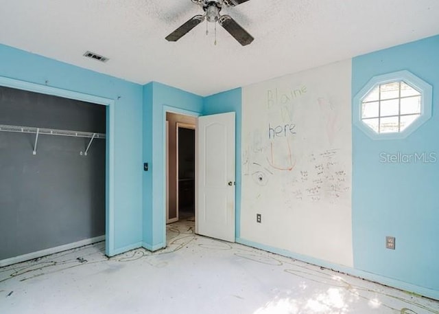 106 Thurston Pl, Crestview, FL 32536 - unfurnished bedroom featuring a closet, baseboards, a textured ceiling, and ceiling fan
