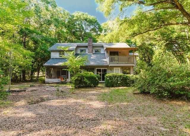 106 Thurston Pl, Crestview, FL 32536 - rear view of house with a balcony and a chimney