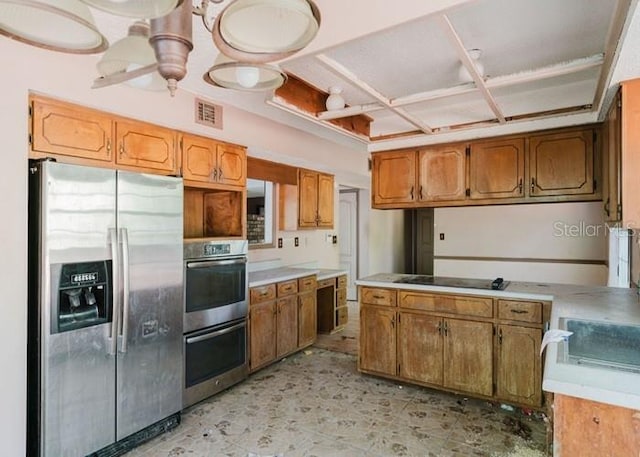 106 Thurston Pl, Crestview, FL 32536 - kitchen featuring stainless steel appliances, brown cabinetry, light countertops, and coffered ceiling