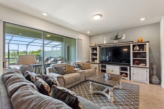 living room featuring recessed lighting, a sunroom, a textured ceiling, and light tile patterned floors