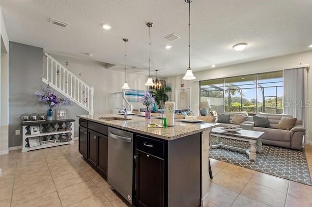 kitchen with light tile patterned floors, visible vents, stainless steel dishwasher, open floor plan, and a sink