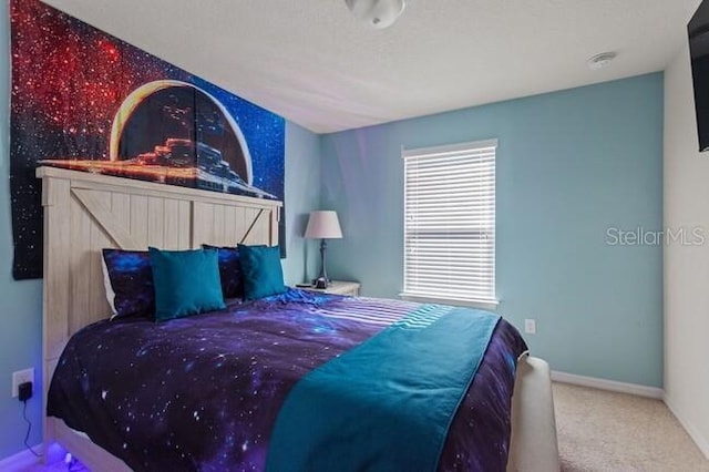 bedroom featuring carpet floors and baseboards