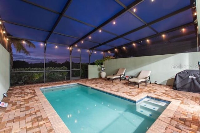 view of swimming pool featuring a fenced in pool, glass enclosure, and a patio area