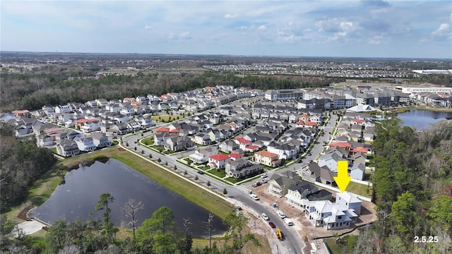 bird's eye view featuring a water view and a residential view