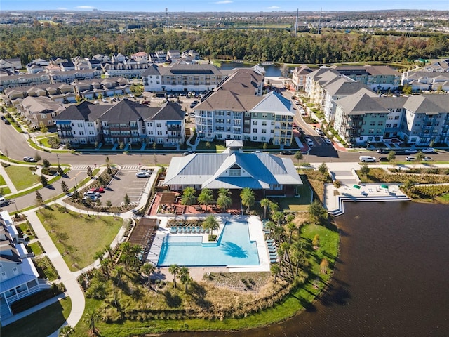 birds eye view of property with a water view and a residential view