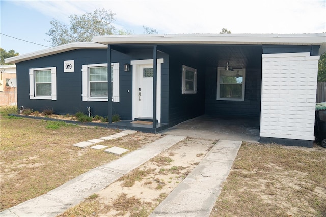 view of front of property with an attached carport and a front yard