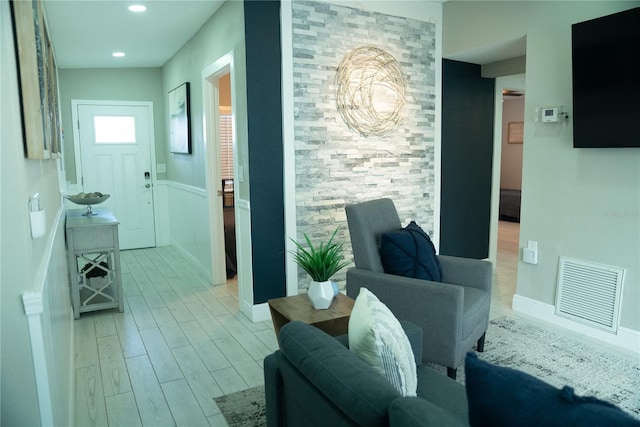 interior space featuring light wood finished floors, baseboards, visible vents, and recessed lighting