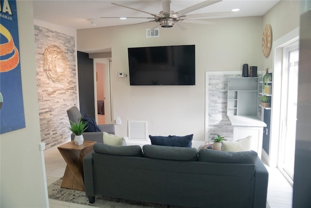 living room featuring ceiling fan, visible vents, wood finished floors, and recessed lighting