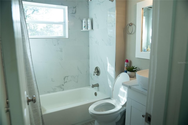 bathroom with tub / shower combination, vanity, and toilet