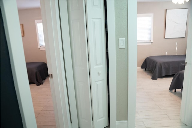 corridor with light wood-style floors