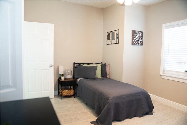 bedroom featuring light wood-style flooring and baseboards