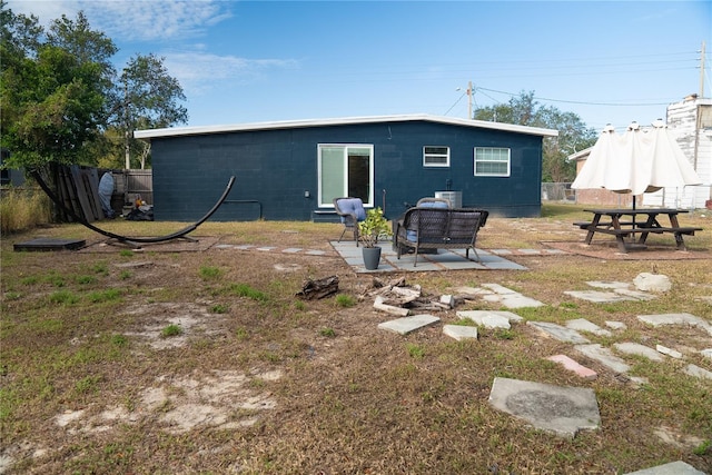 rear view of property with a patio and fence