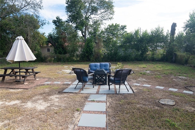 view of yard with outdoor lounge area, a patio, and fence