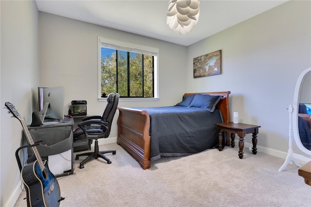 bedroom with light carpet and baseboards