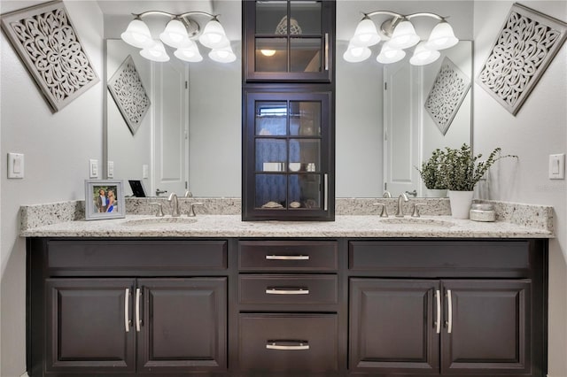 full bathroom featuring double vanity and a sink