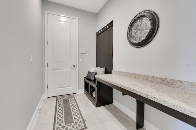 mudroom with baseboards and light tile patterned floors