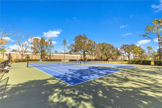 view of sport court featuring fence