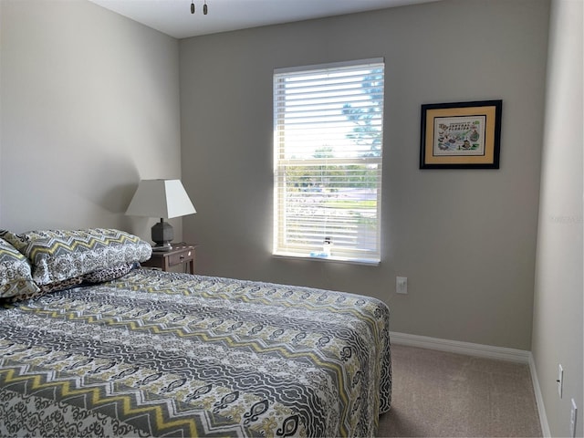 carpeted bedroom featuring baseboards