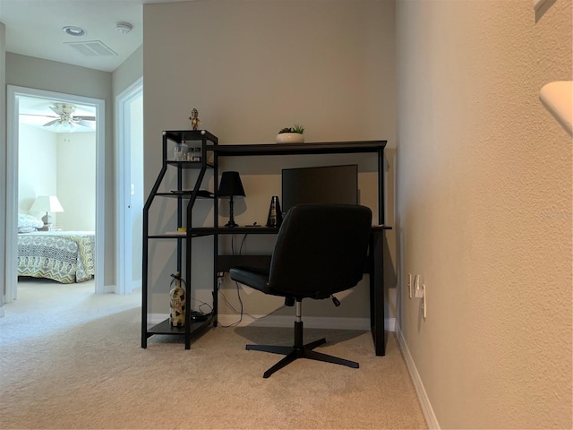 carpeted office featuring visible vents, a textured wall, and baseboards