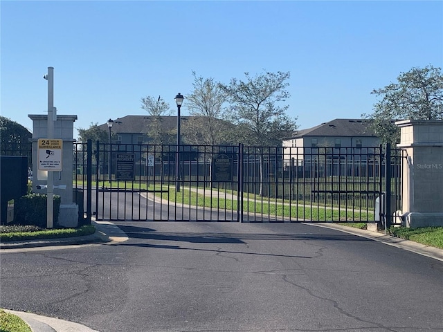 view of gate with a residential view and fence