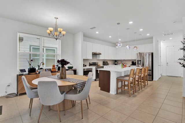 dining area with light tile patterned floors, visible vents, a notable chandelier, and recessed lighting