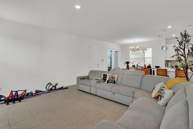 living area with baseboards, light tile patterned floors, recessed lighting, and an inviting chandelier