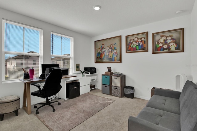 office area with light carpet and baseboards