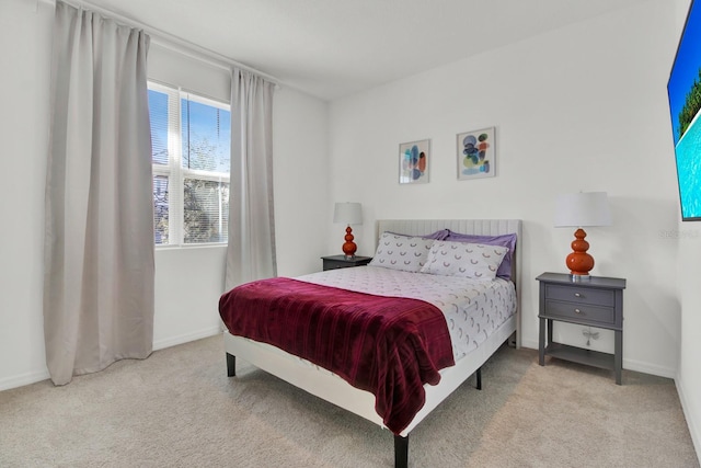 bedroom featuring carpet and baseboards