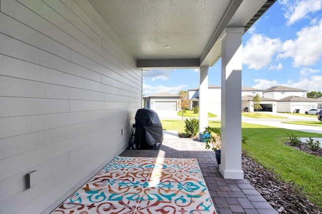 view of patio / terrace with a grill and a residential view